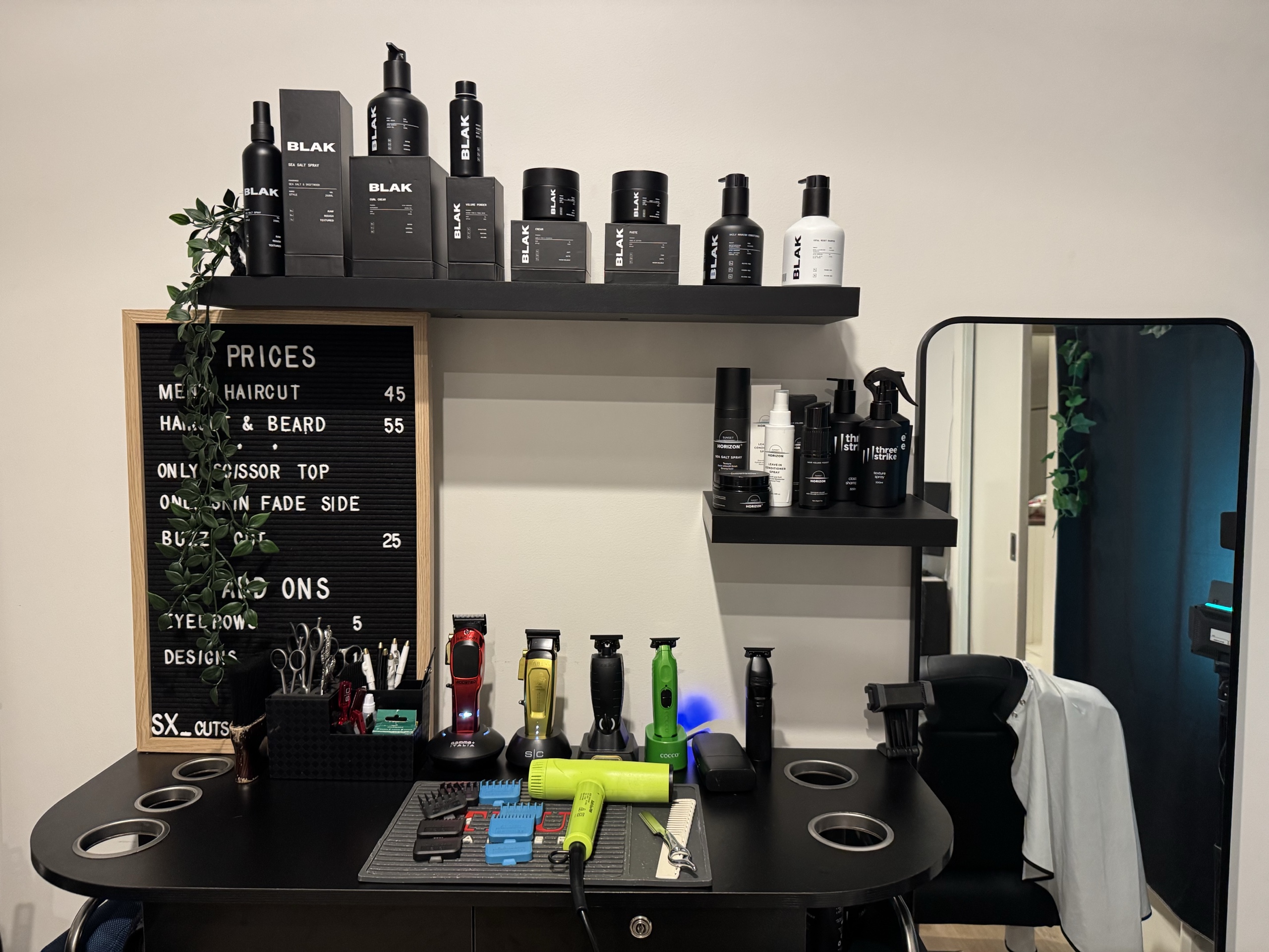 Saul’s workstation with styling products, clippers and mirror